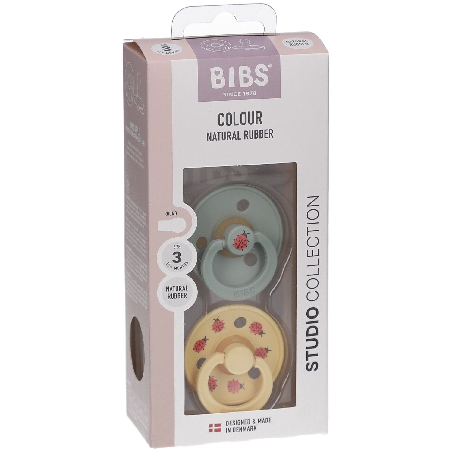 Verpackung mit zwei Schnullern. Grün und gelb mit roten Marienkäfern. Marke BIBS. Alter 18+ Monate.