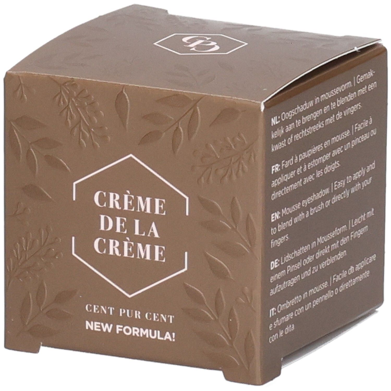 Braune Verpackung mit geprägten Blättern. Text: Crème de la Crème, Cent Pur Cent, New Formula. Oben Logo.