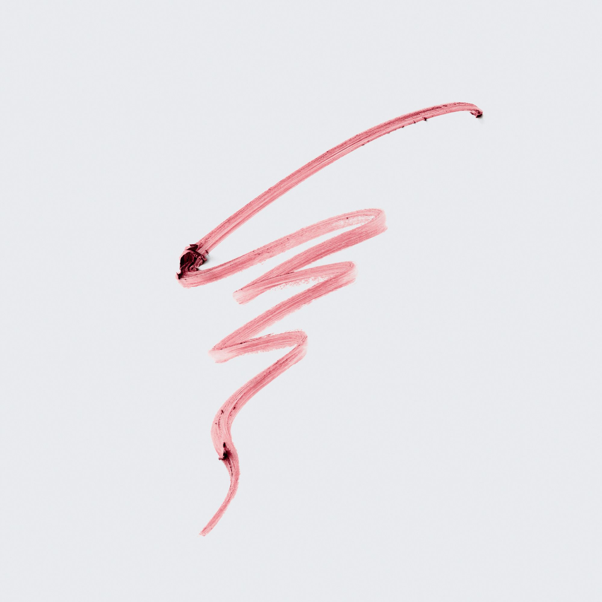 Rosa Lippenstiftstrich auf hellem Hintergrund. Textur und Farbe des Produkts sind sichtbar.