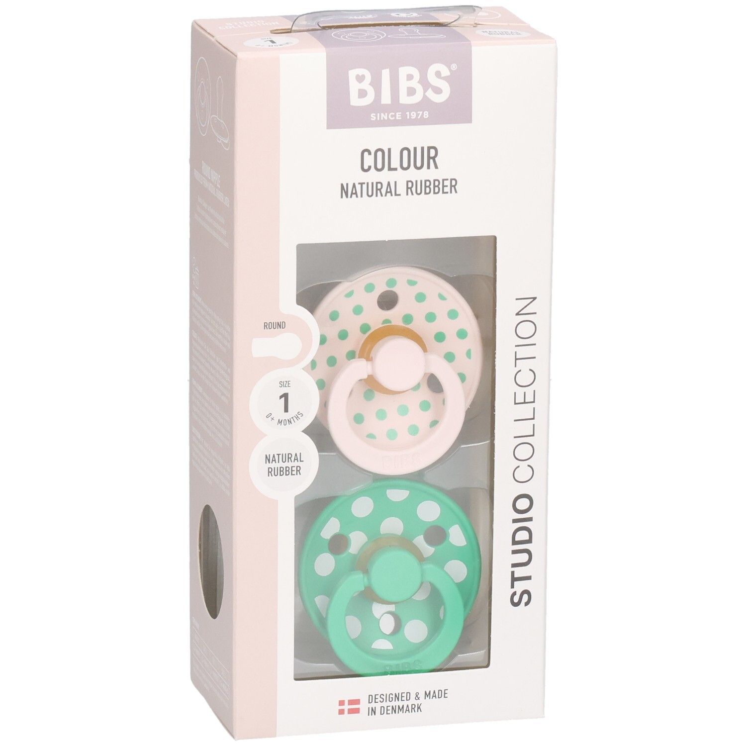Verpackung mit zwei Schnullern. Rosa und grüne Schnuller mit weißen Punkten. Marke: BIBS. Naturgummi.