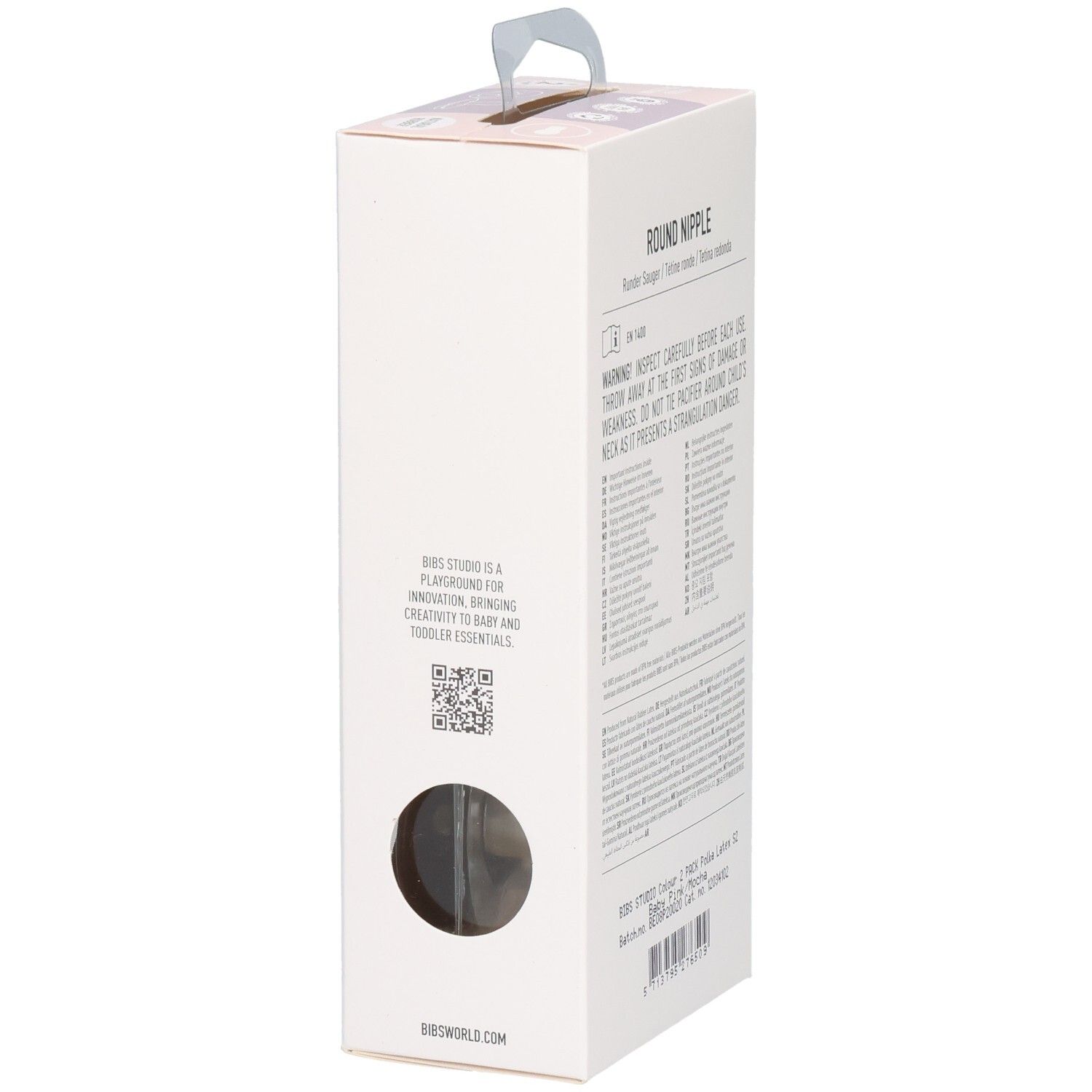 Seitenansicht der Verpackung mit Text. Text: Round Nipple, Warnhinweise, BIBS Studio ist ein Spielplatz.
