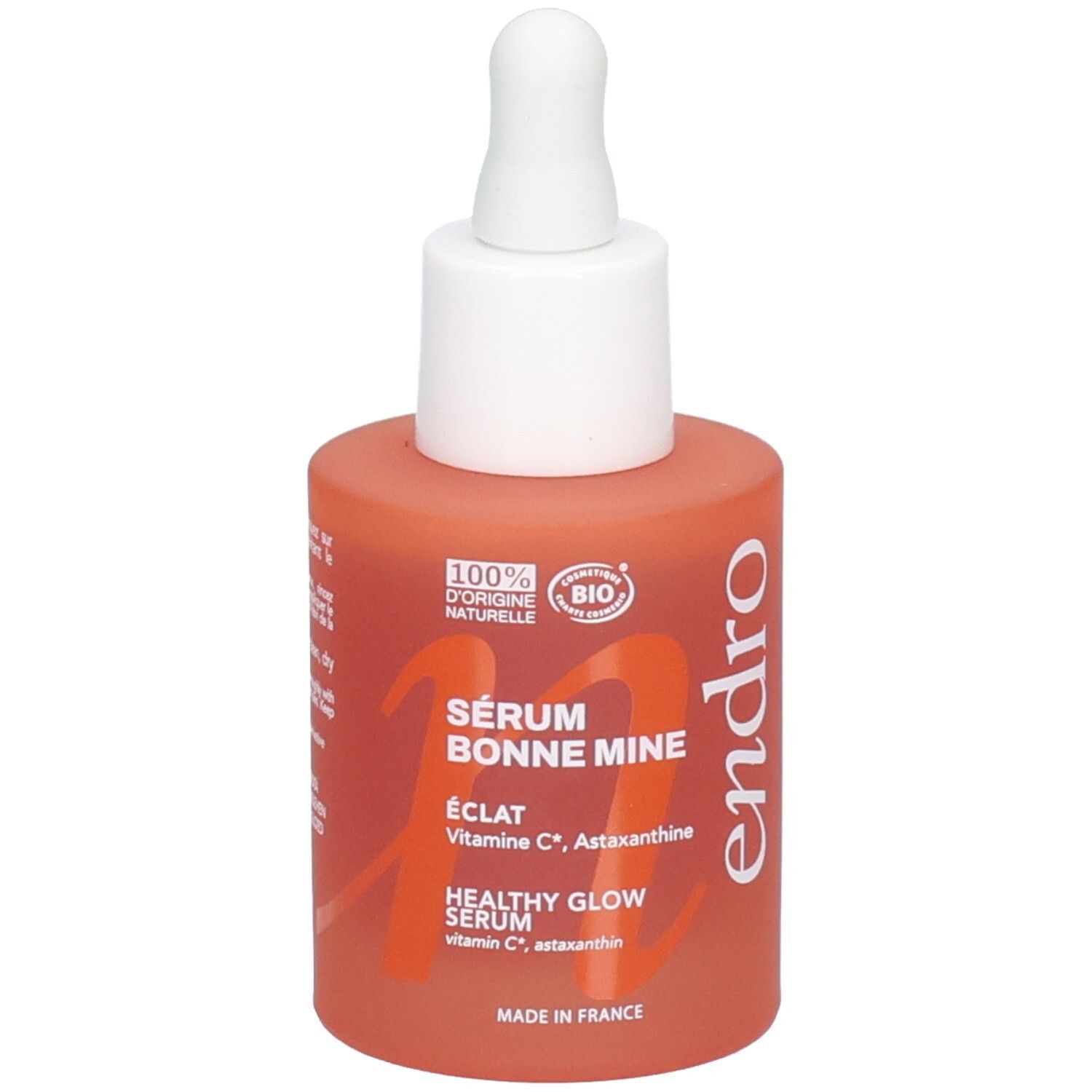 Endro Sérum Bonne Mine Flasche mit Pipette. Orangefarbenes Glas mit weißem Verschluss.