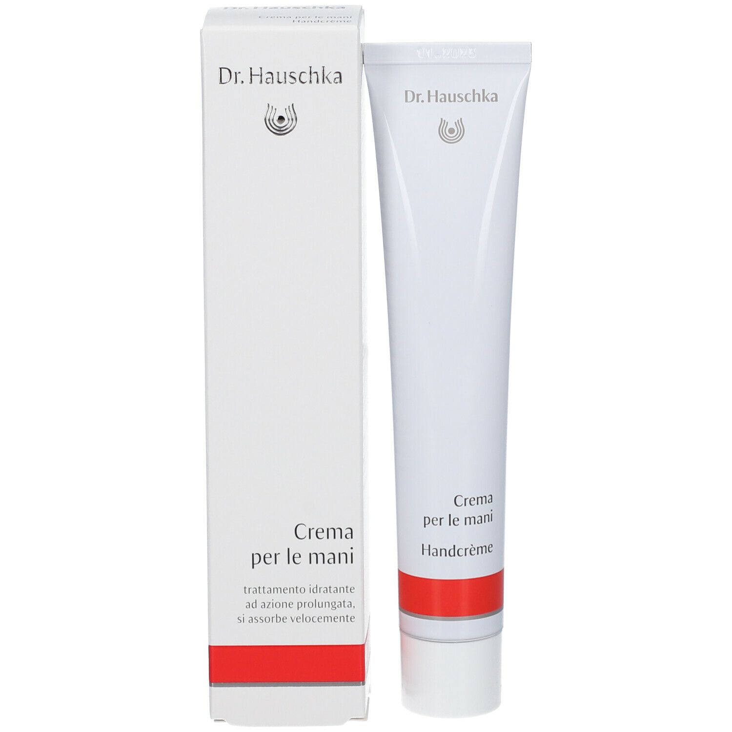 Tube blanc et boîte. Sur la boîte, "Dr. Hauschka" et "Crema per le mani".