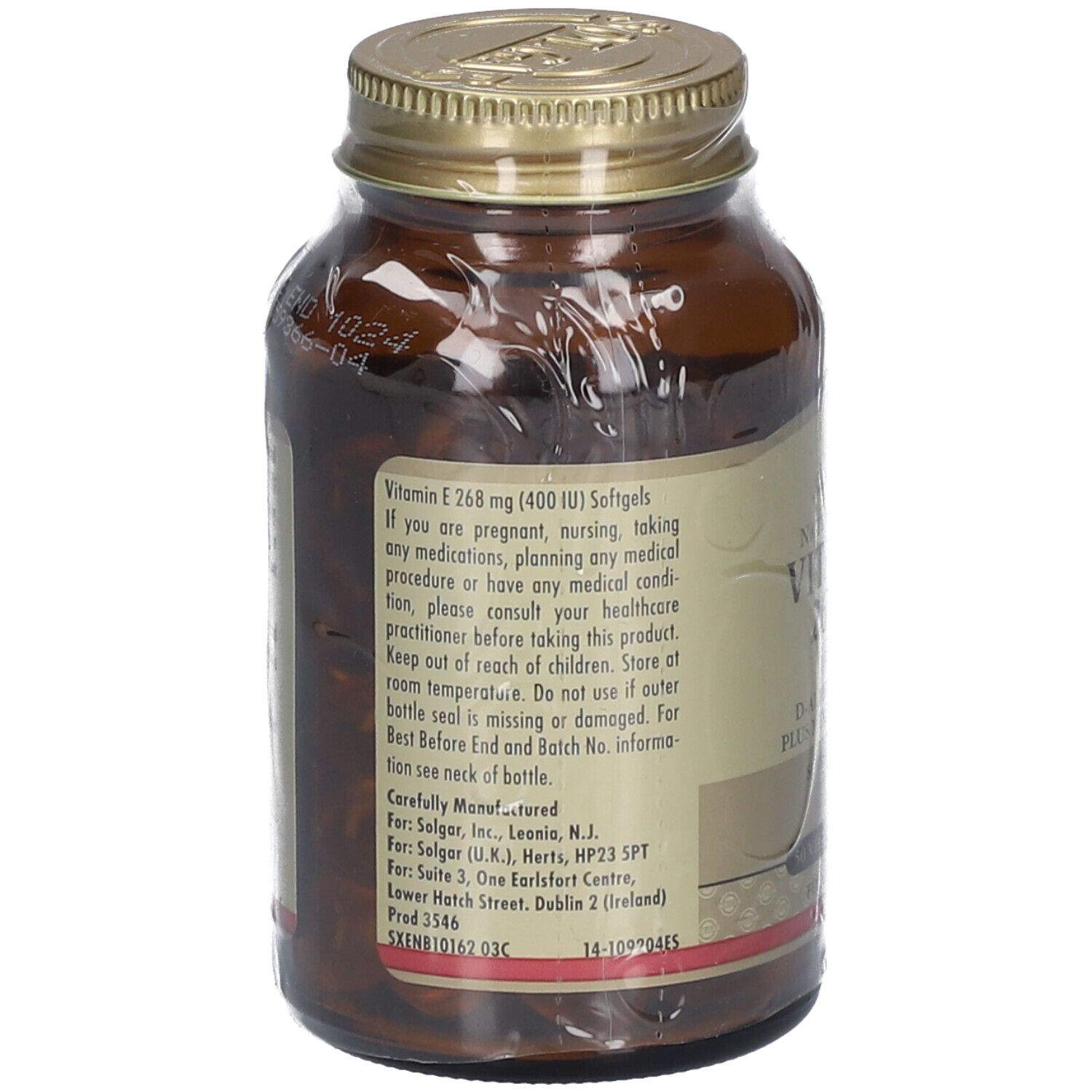 Achterkant van de bruine glazen fles. Etiket met informatie: Vitamine E, gebruiksaanwijzing, fabrikant informatie.