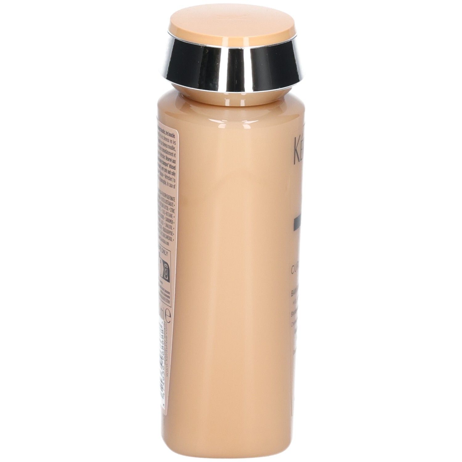 Seitenansicht der Kérastase Curl Manifesto Shampoo-Flasche in Beige.