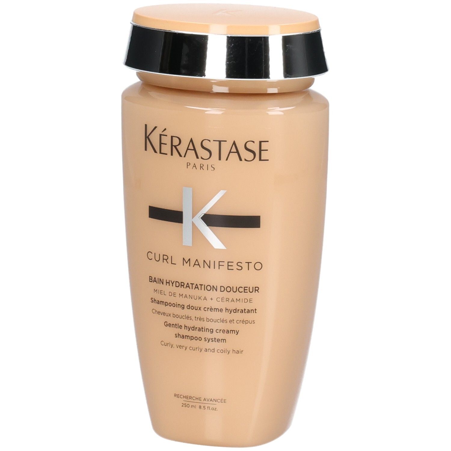 Kérastase Curl Manifesto Shampoo in beigefarbener Flasche mit silbernem und schwarzem Deckel.