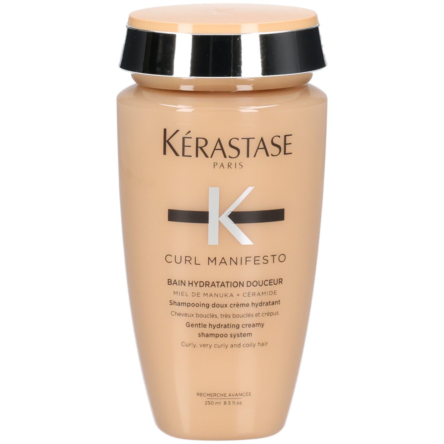 Kérastase Curl Manifesto Shampoo in beigefarbener Flasche mit silbernem und schwarzem Deckel.