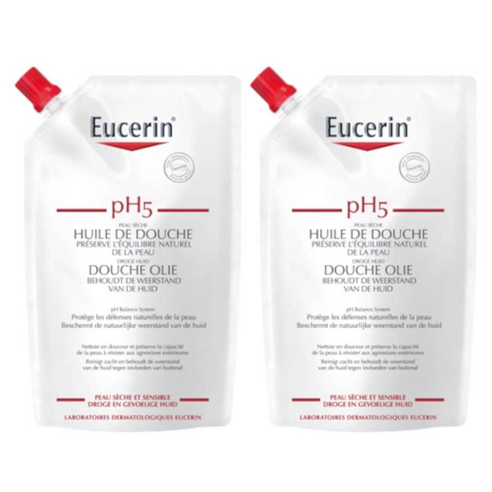 Deux recharges blanches avec bouchon rouge. Inscription : Eucerin pH5 Huile de douche. Pour peaux sèches et sensibles.