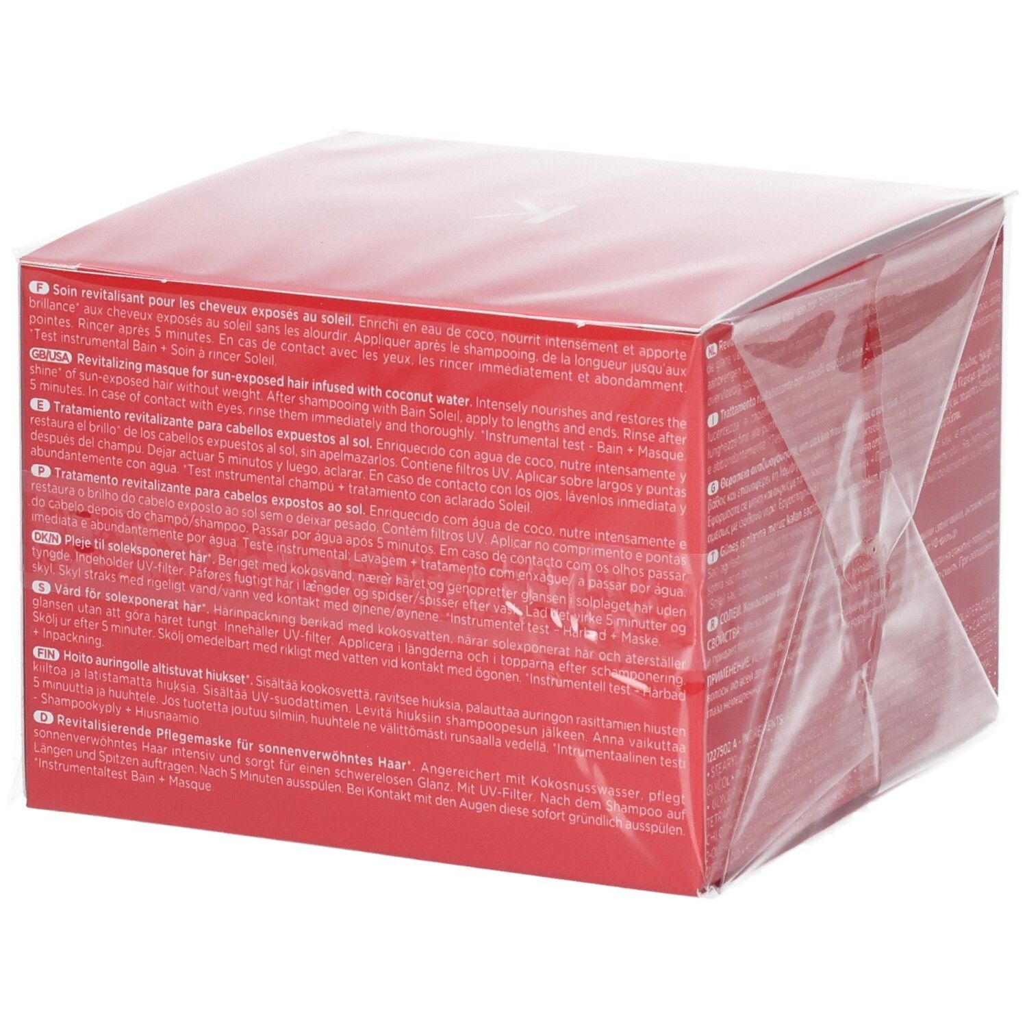 Rote Kérastase Soleil Après-Soleil Verpackung mit Produktbeschreibung in verschiedenen Sprachen, inklusive deutscher.