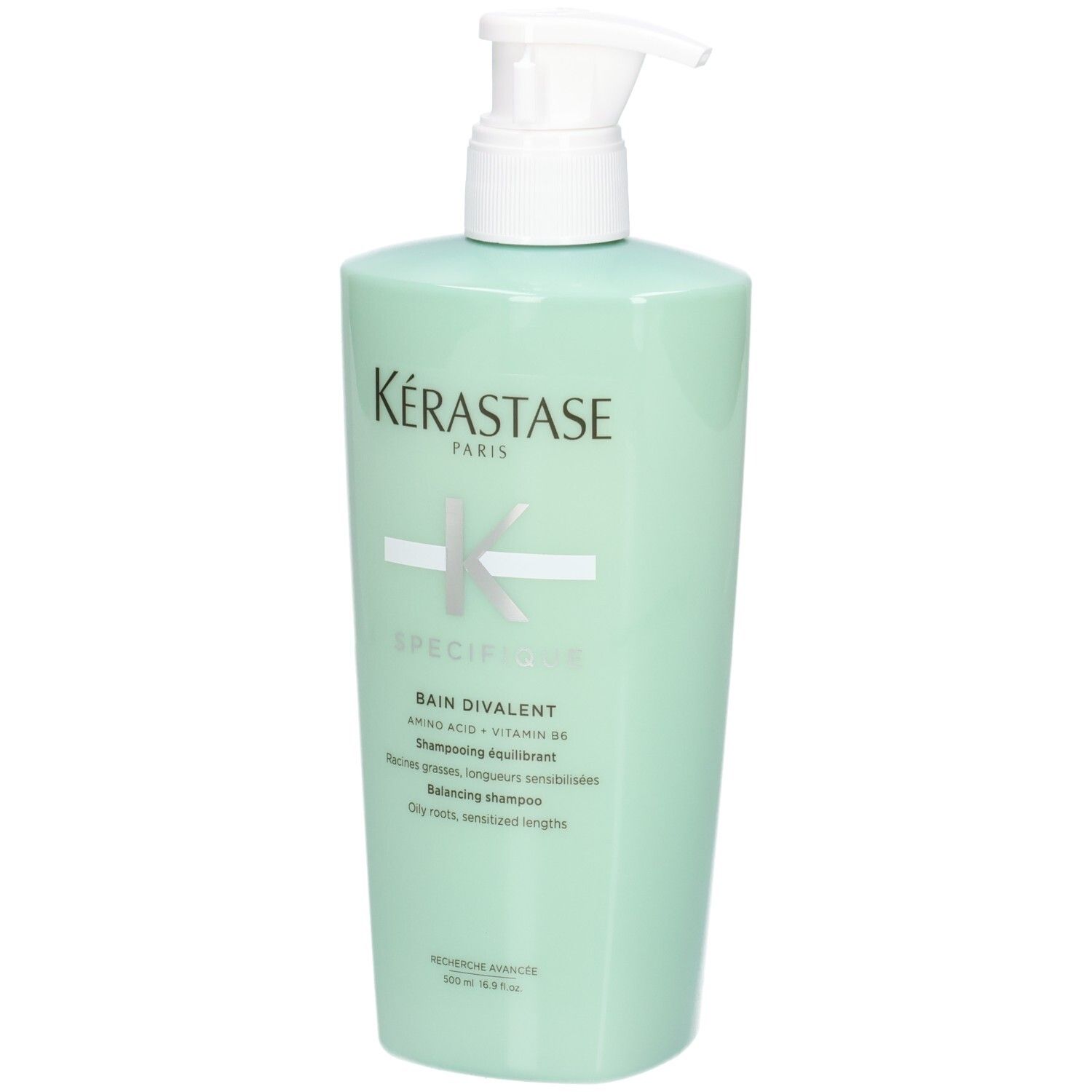 Kérastase Bain Divalent Balancing Shampoo in mint green bottle with pump dispenser.