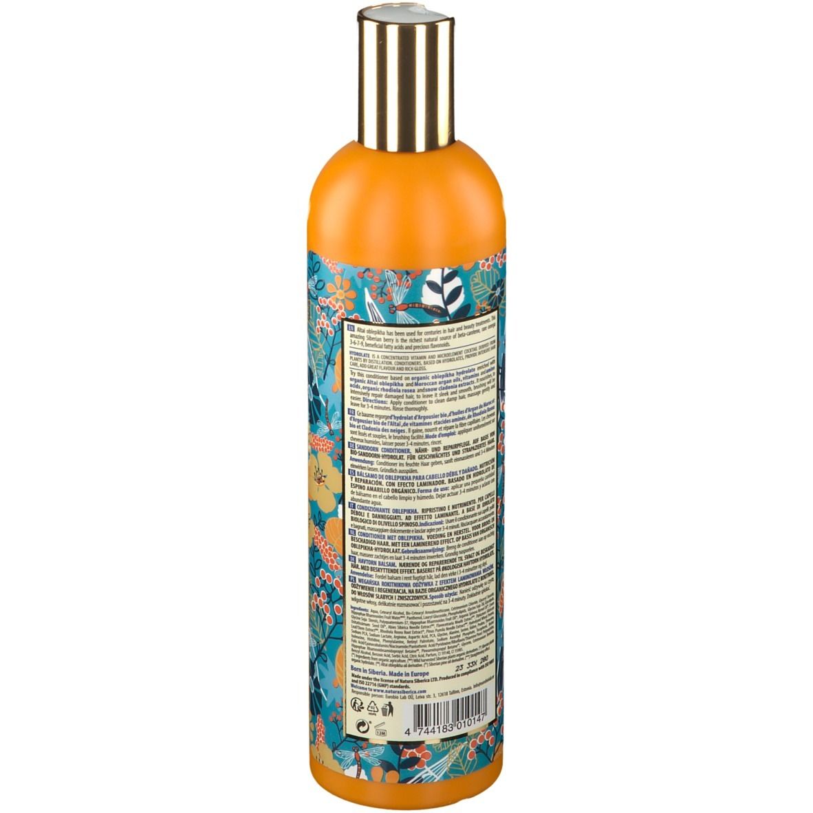 Rückseite der orangefarbenen Flasche. Text in mehreren Sprachen. Floralmuster.