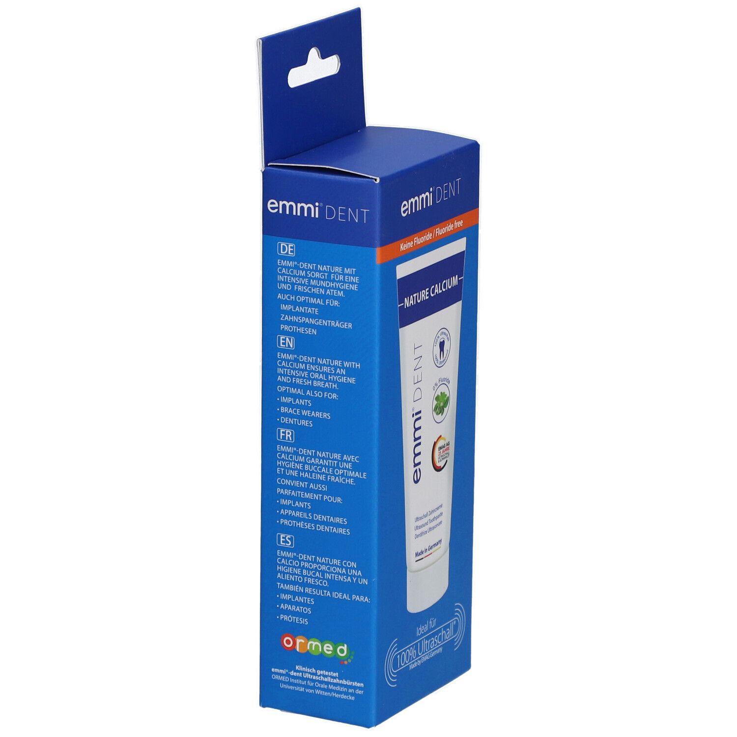 Emballage bleu avec tube de dentifrice. Inscription : emmi®-dent, Nature Calcium, sans fluor. Texte en allemand, anglais, français, espagnol.