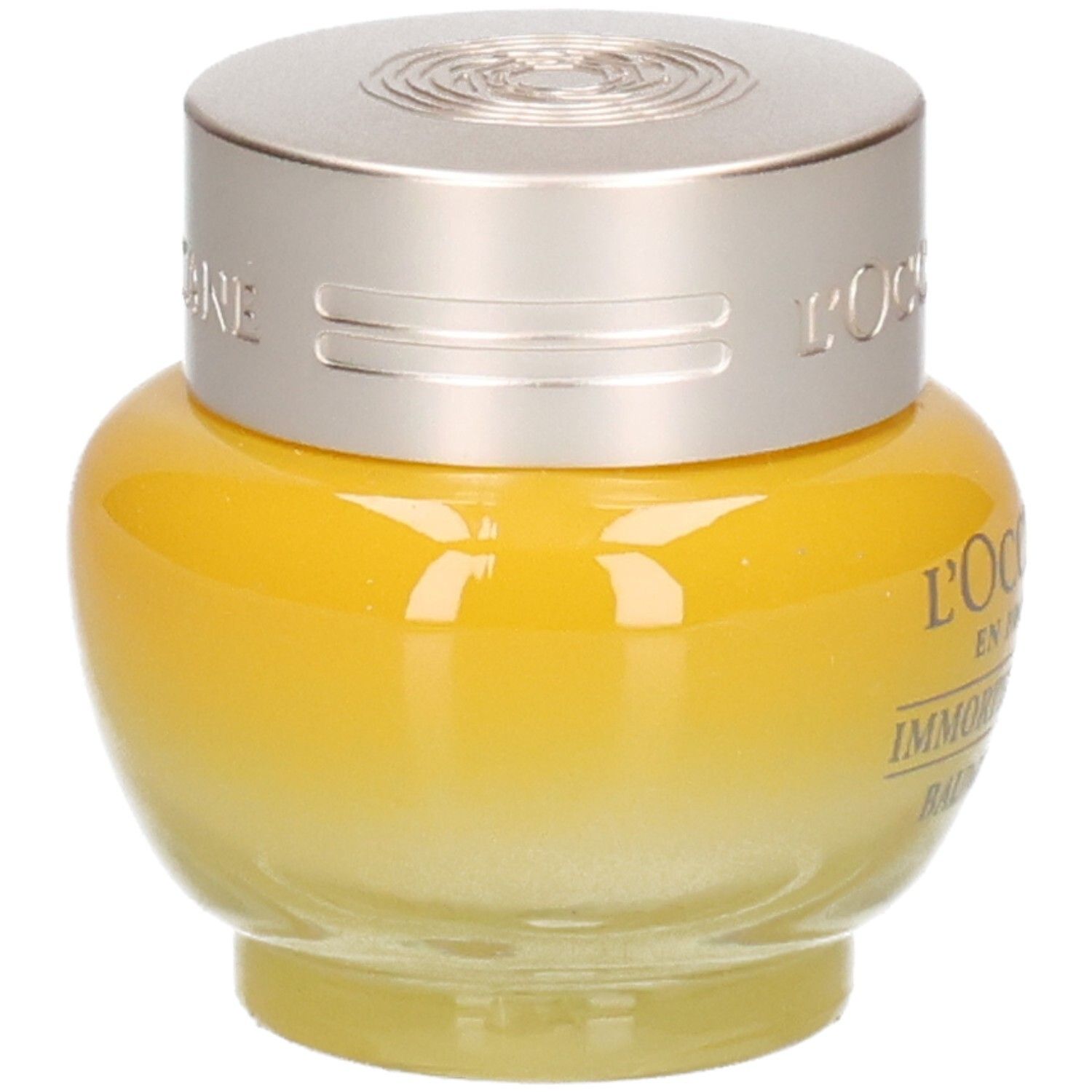 L'OCCITANE Immortelle Divine Augenbalsam, Seitenansicht eines gelben Glasbehälters mit silbernem Deckel.