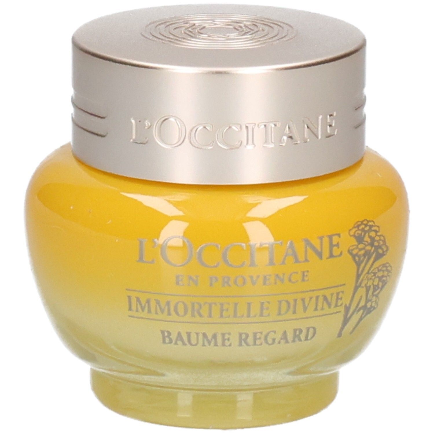 L'OCCITANE Immortelle Divine Augenbalsam, gelber Glasbehälter mit silbernem Deckel, leicht schräg.