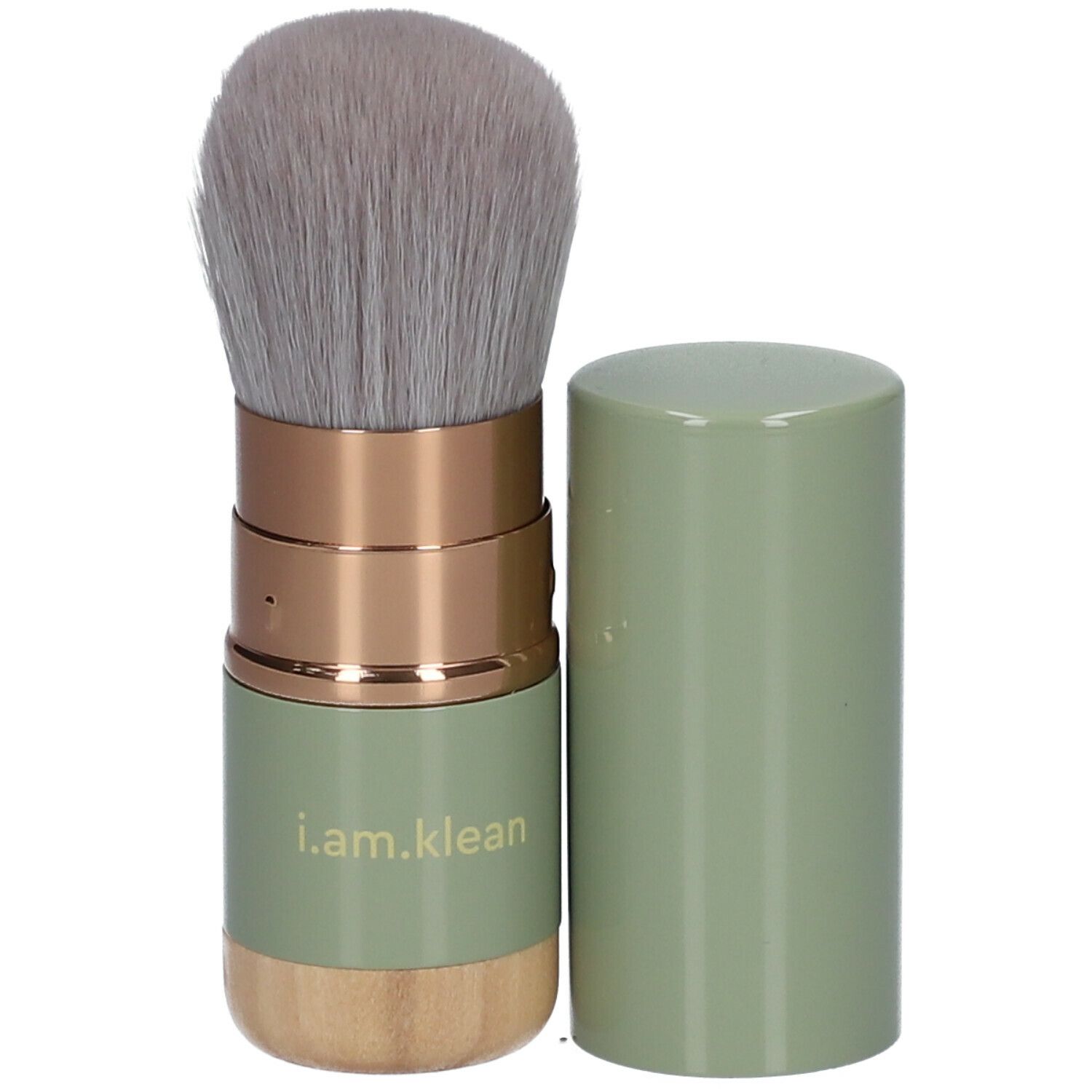 i.am.klean Versenkbarer Kabuki-kwast. Groene handgreep, gouden elementen, grijze haren. Dop ernaast.