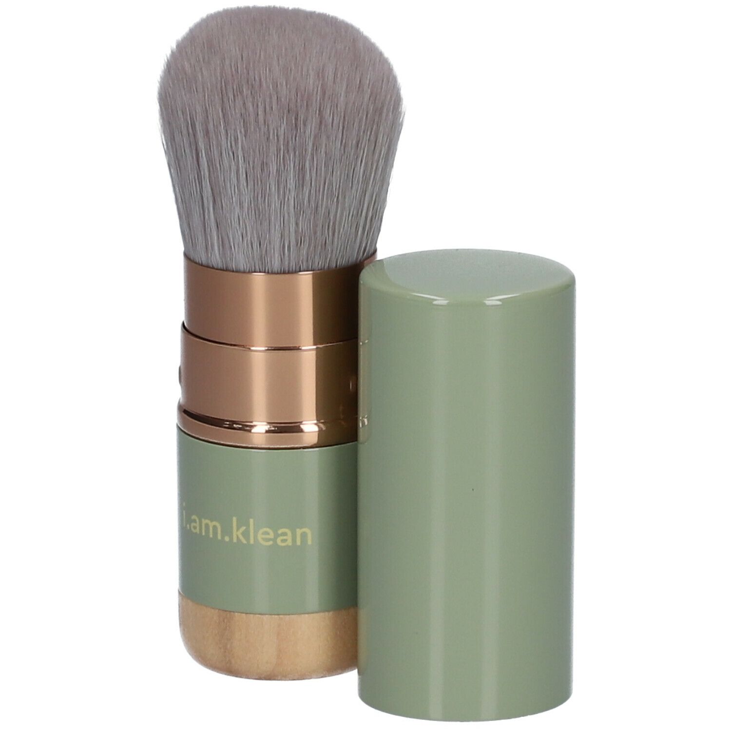 i.am.klean Versenkbarer Kabuki-kwast. Groene handgreep, gouden elementen, grijze haren. Dop ernaast.