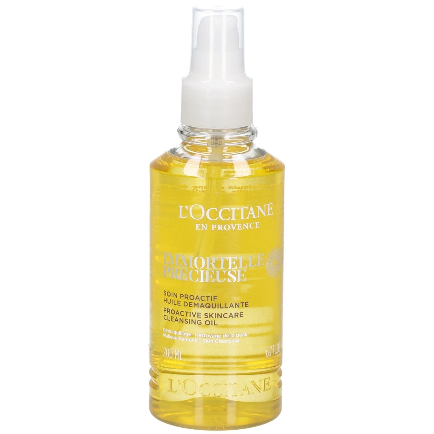 L'OCCITANE Immortelle Reinigungsöl in klarer Sprühflasche mit gelbem Öl.