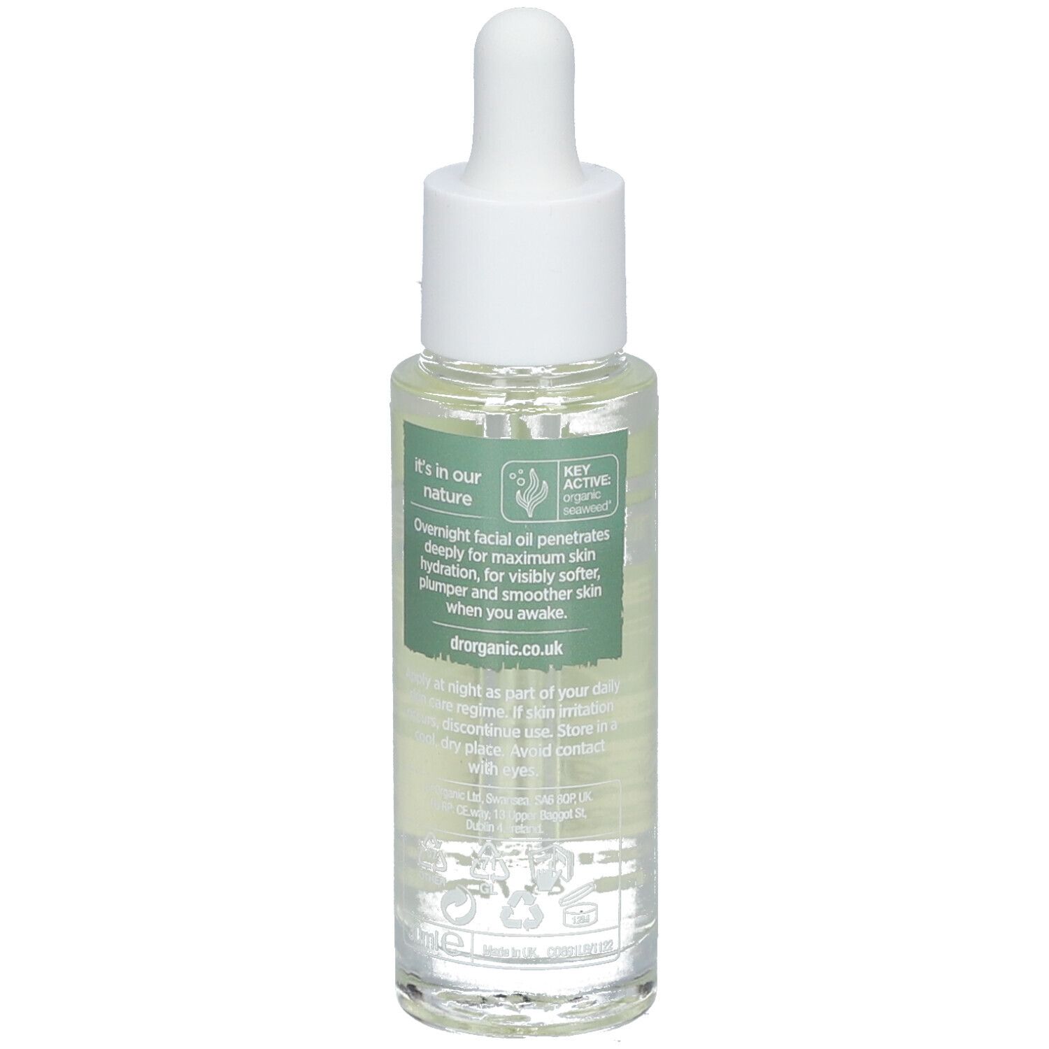 Rückseite einer Glasflasche mit klarer Flüssigkeit und Pipette. Text: Overnight facial oil... dr.organic.co.uk. Vegan.