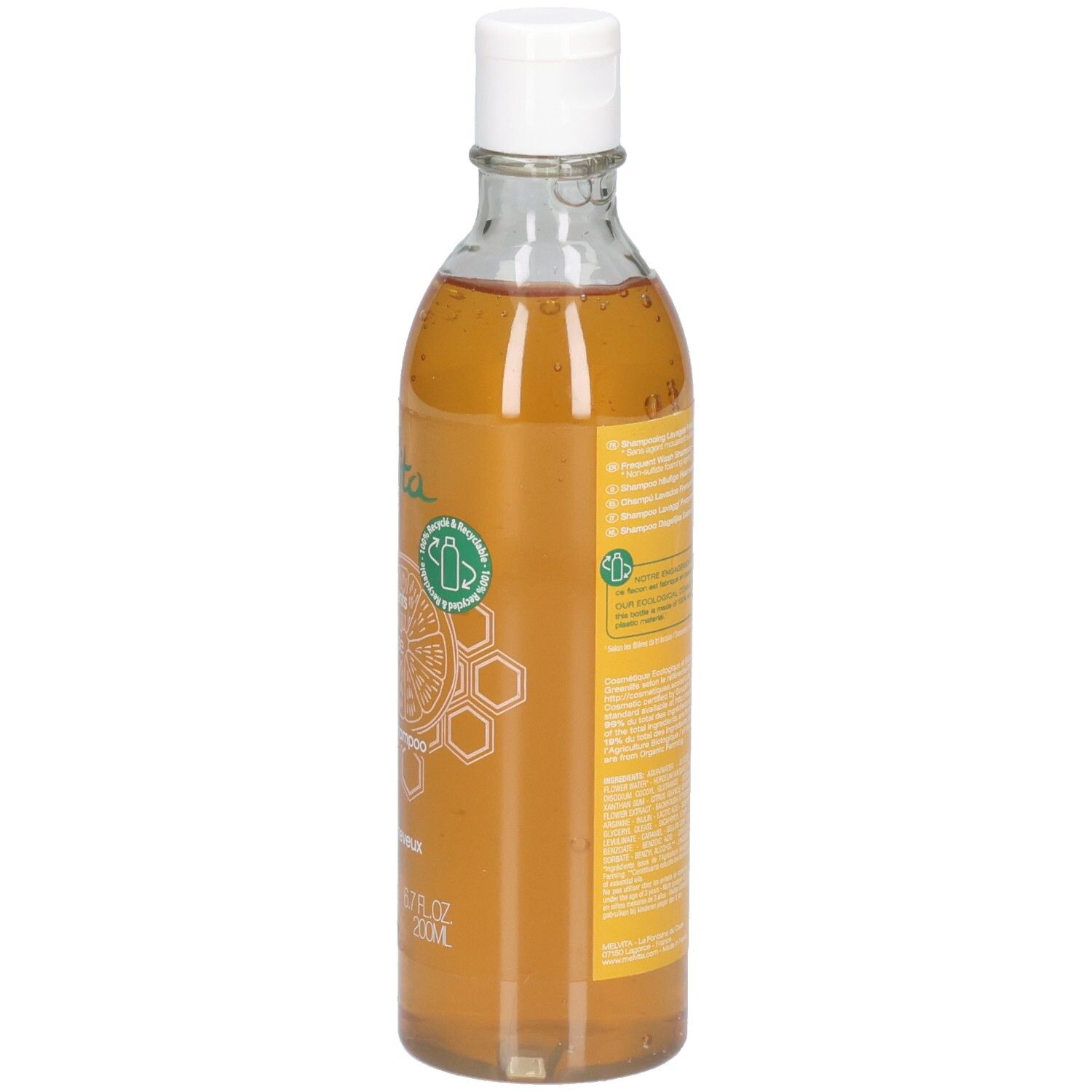 Klare Glasflasche mit weißem Verschluss, gefüllt mit honigfarbener Flüssigkeit. Gelbes Etikett mit Bienenwabenmuster.