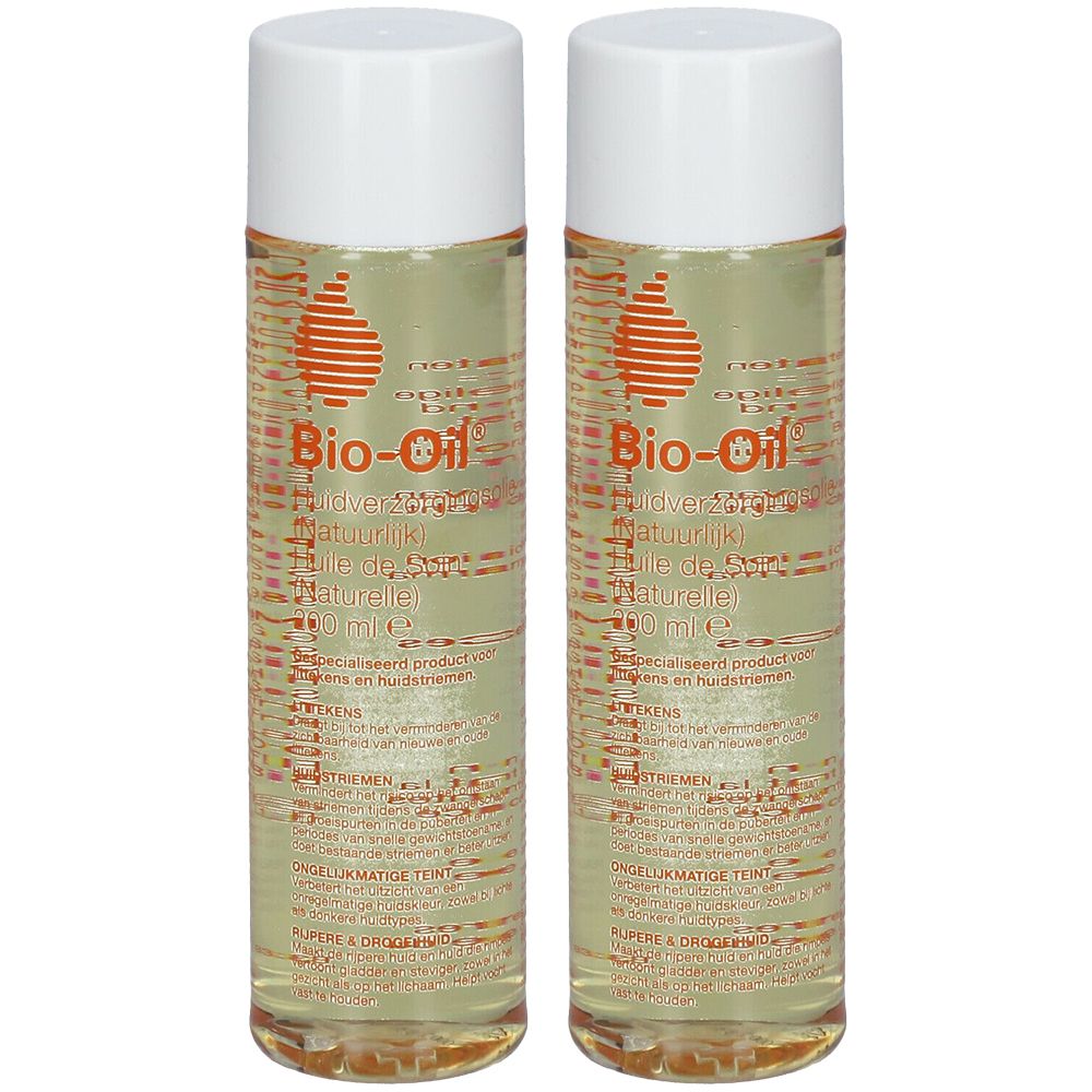 Deux flacons de Bio-Oil avec bouchons blancs. Logo orange en forme de goutte. Texte multilingue sur l'étiquette.