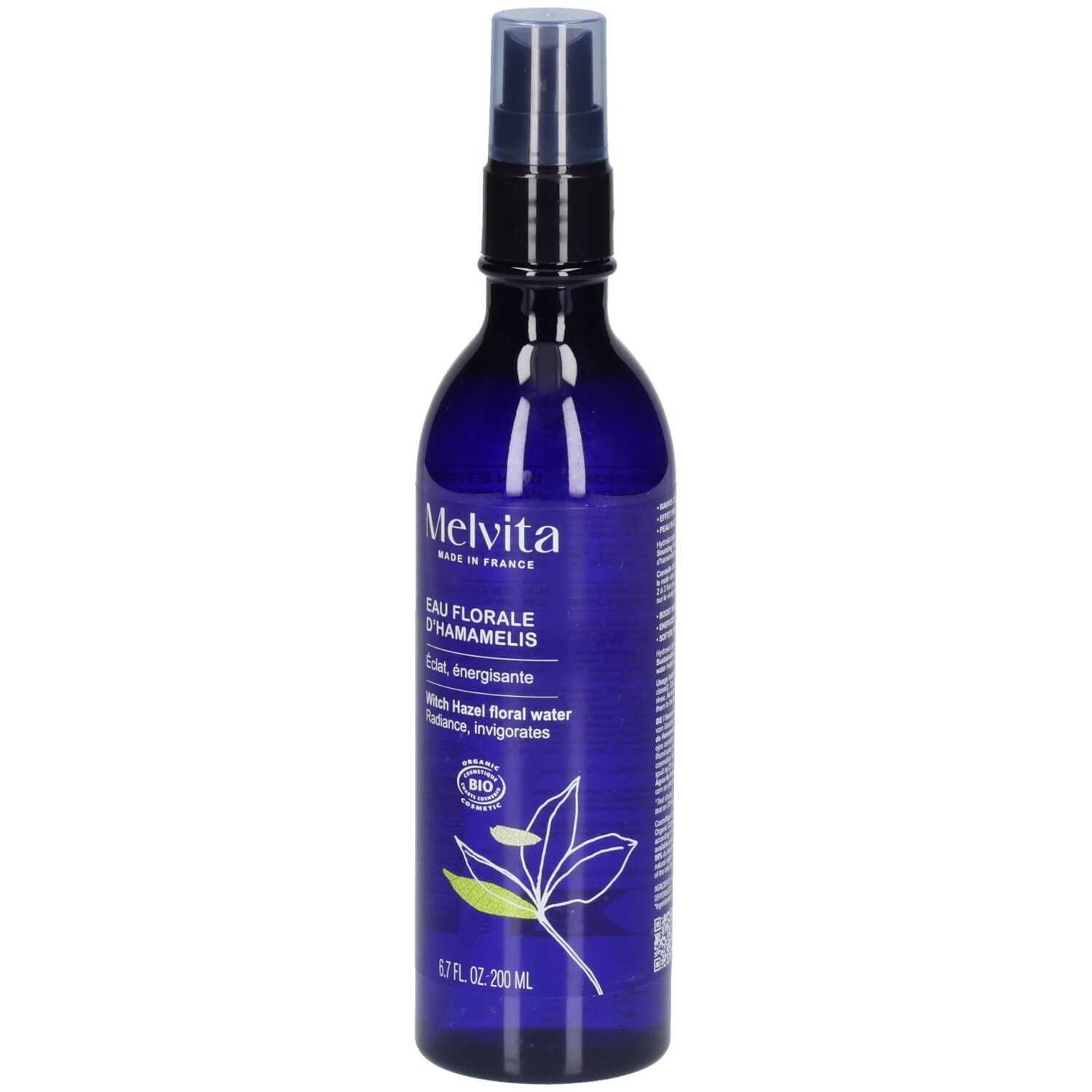 Melvita Eau Florale d’Hamamélis: Blaue Sprühflasche mit Etikett und Pflanzenmotiv.