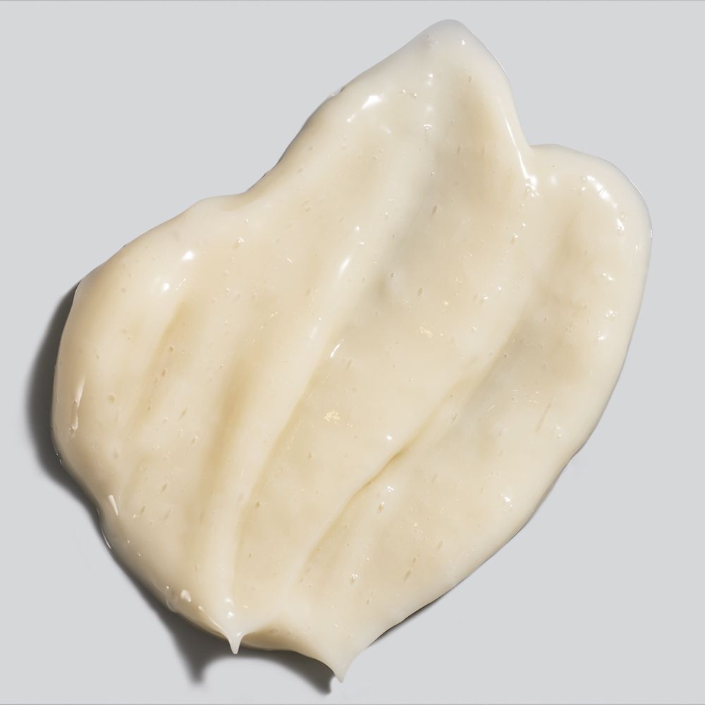Close-up van een crèmekleurige gelcrème. Textuur glad, licht golvend.