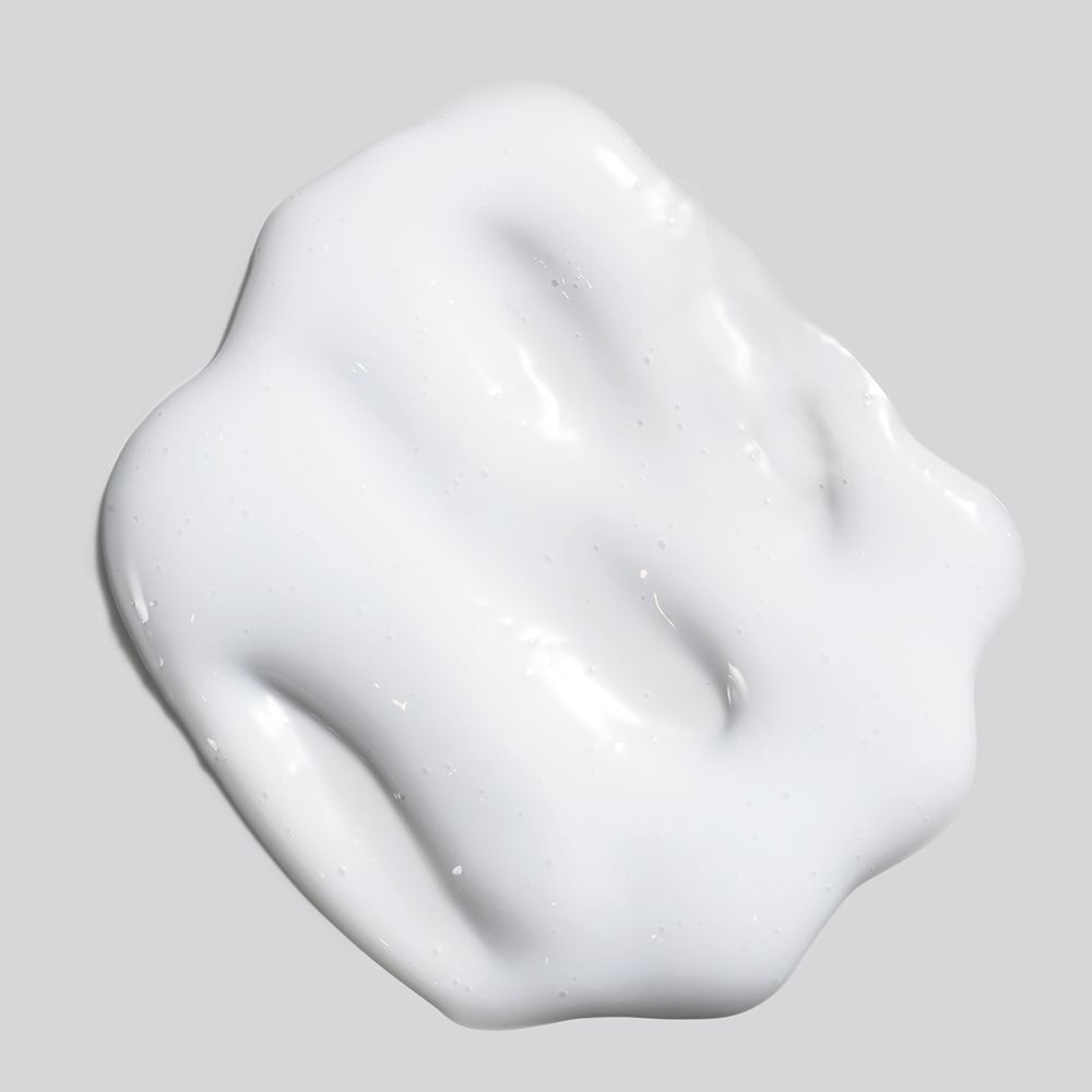 Weißes Creme-Produkt auf grauem Hintergrund. Textur sichtbar.