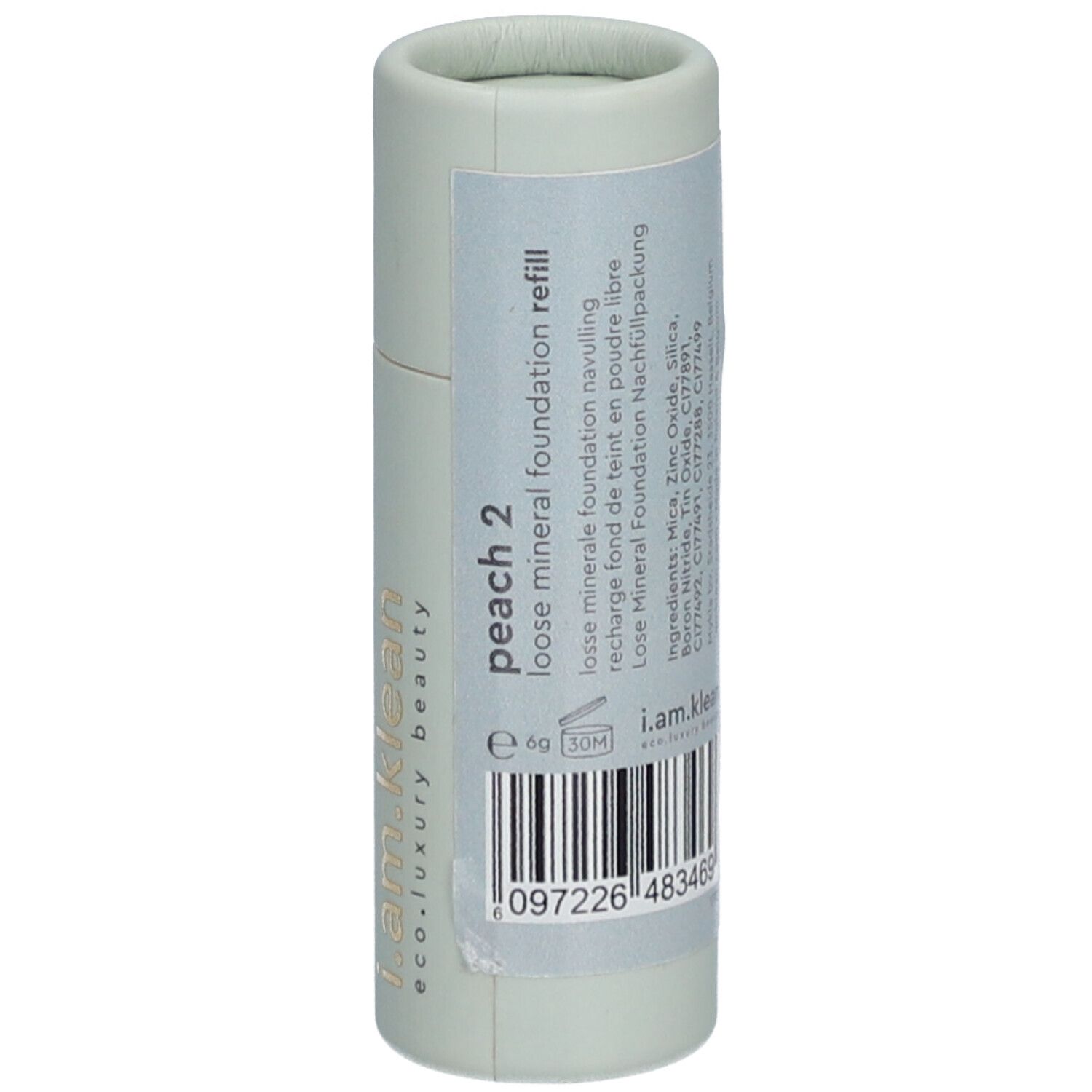 Recharge cylindrique vert clair avec inscription "peach 2 loose mineral foundation refill". Code-barres.