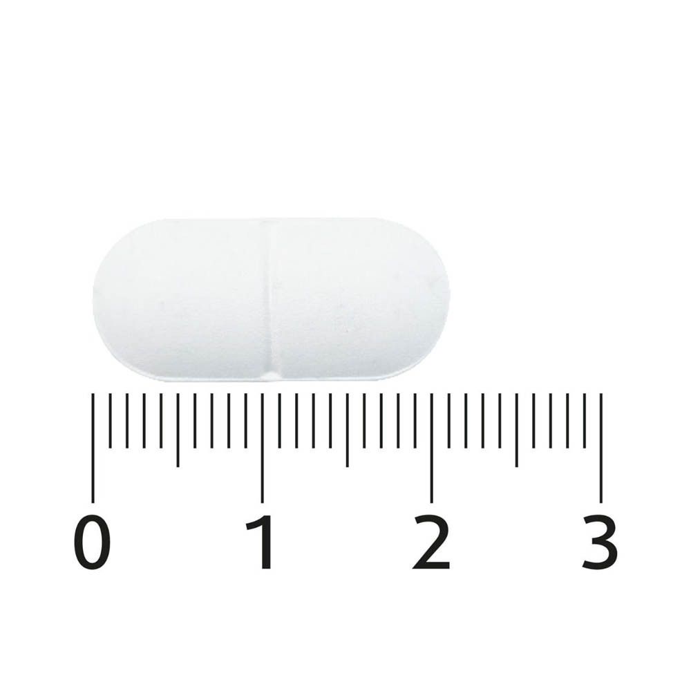 Close-up van een witte, ovale tablet. Met schaal voor maatbepaling.