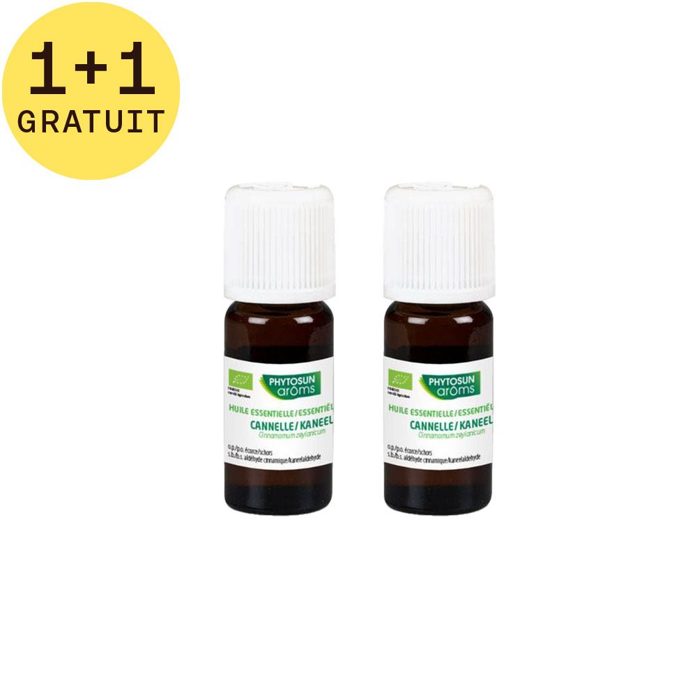 Deux petites bouteilles marron avec bouchons blancs. Étiquettes avec nom et logo du produit. Texte: Huile essentielle Cannelle.