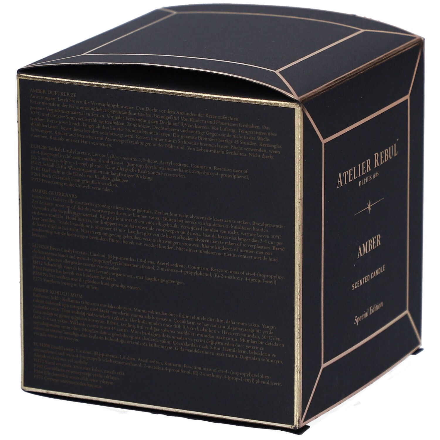 Dos d'une boîte noire carrée avec détails dorés. Texte en plusieurs langues.