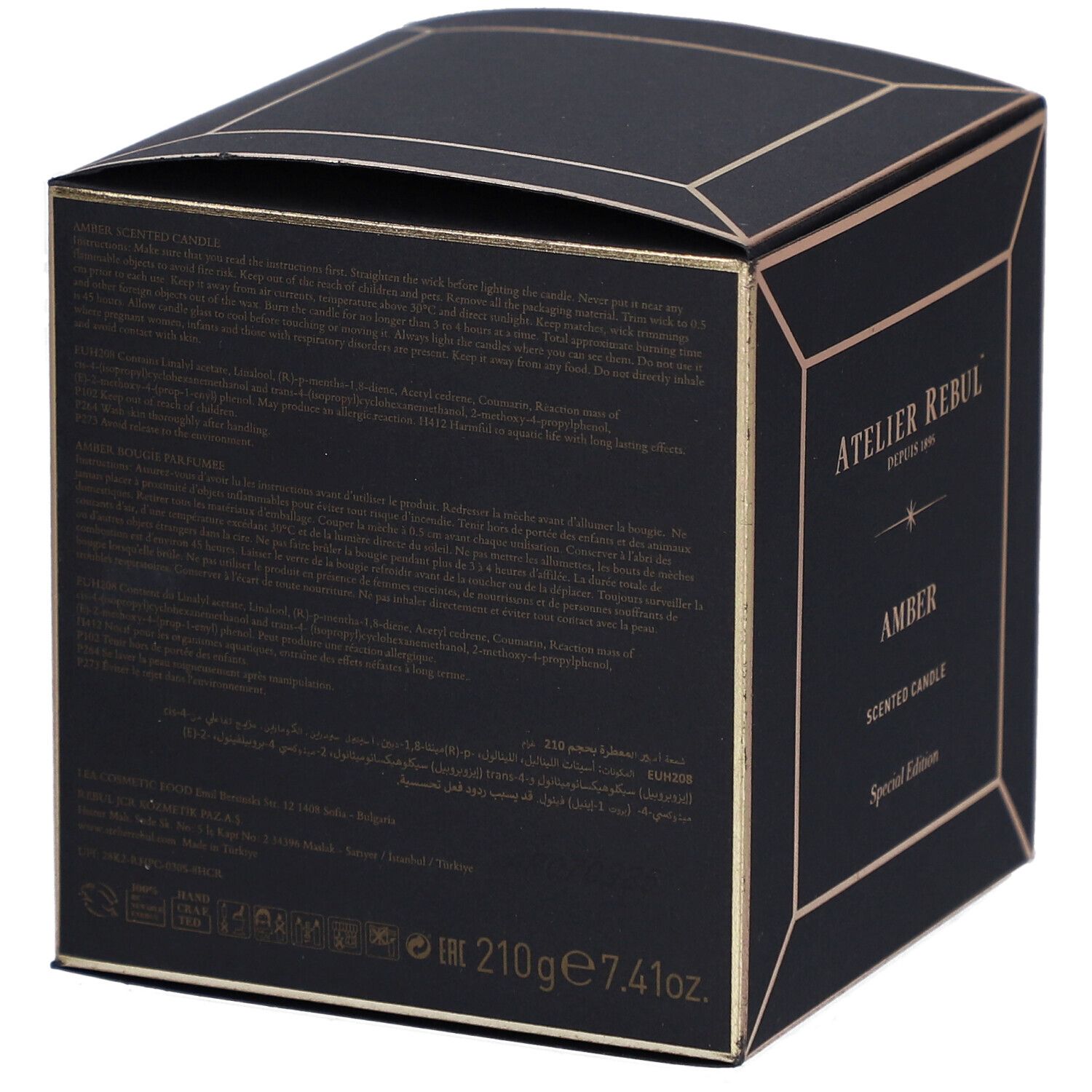 Dos d'une boîte noire carrée avec détails dorés. Texte en plusieurs langues. Volume : 210g 7.41oz.