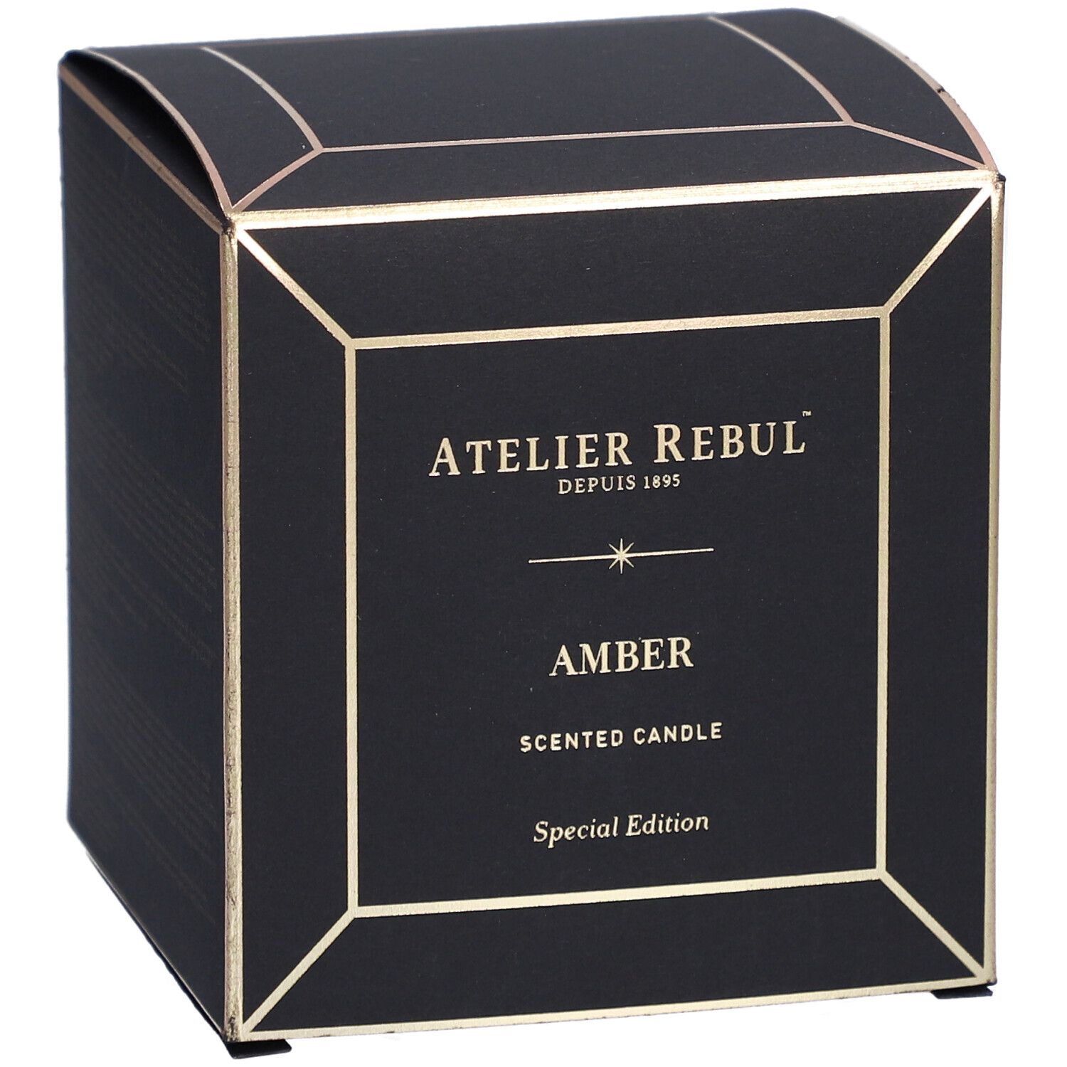 Boîte noire carrée avec détails dorés. Inscriptions : "ATELIER REBUL", "AMBER" et "SCENTED CANDLE".