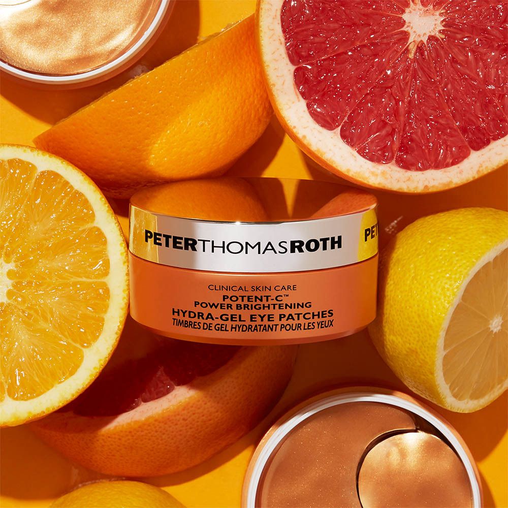 Pot de patchs pour les yeux entouré d'agrumes. Inscription : PETER THOMAS ROTH, POTENT-C, Hydra-Gel Eye Patches.