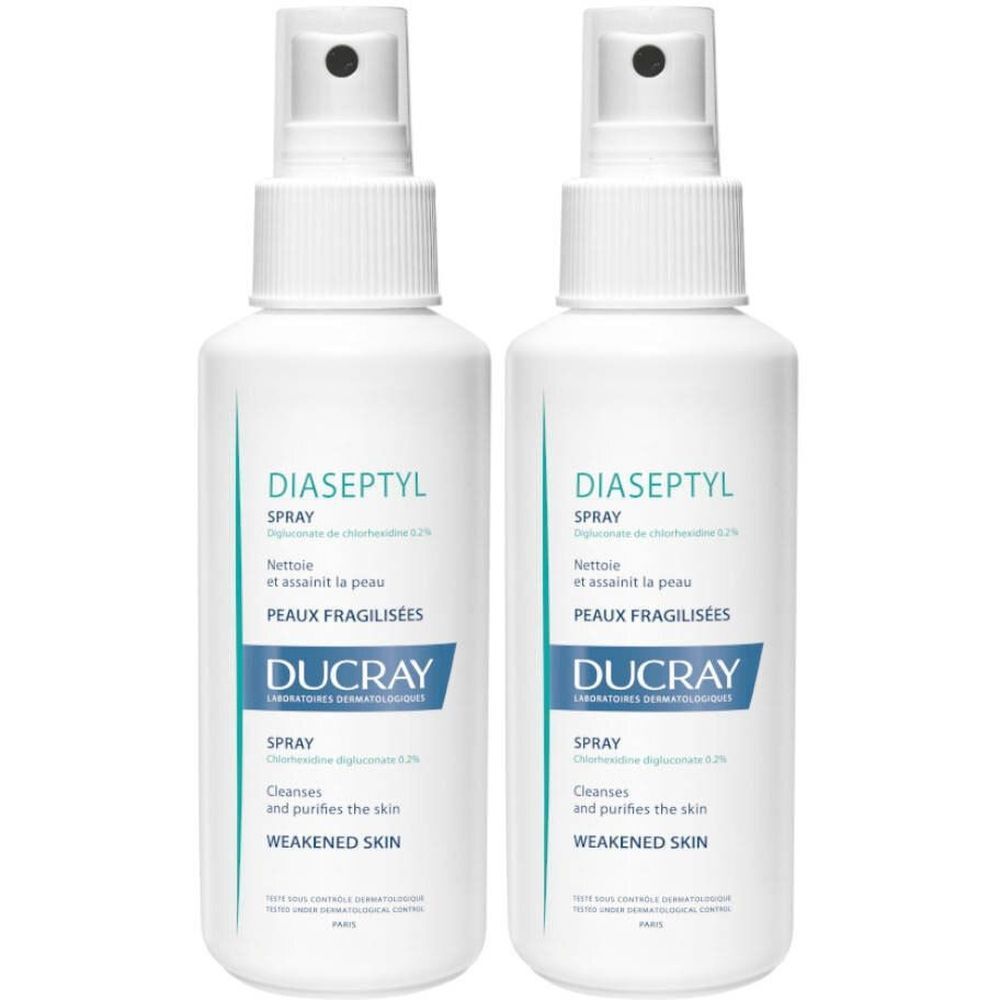 Twee witte sprayflessen met de tekst "DIASEPTYL SPRAY" en "DUCRAY". Tekst: "Reinigt en zuivert de huid, verzwakte huid".