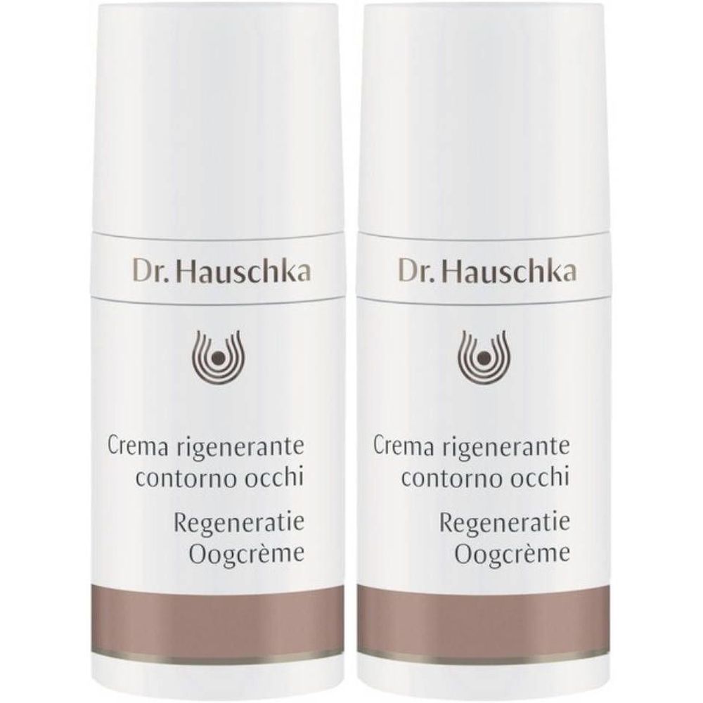 Zwei weiße Flaschen mit braunem Band. Aufschrift: Dr. Hauschka, Creme regenerante contorno occhi, Regeneration Oogcrème.