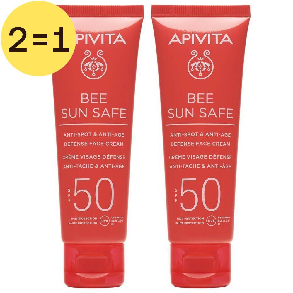 Deux tubes rouges de crème solaire. Inscription: Apivita Bee Sun Safe SPF50. Texte jaune en cercle: 2=1.