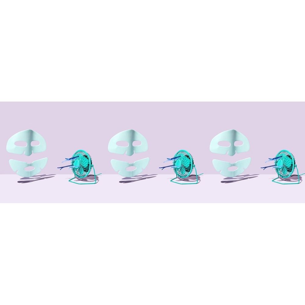 Mehrere Gesichtsmasken-Teile und kleine Ventilatoren. Masken hellblau, geteilt. Ventilatoren türkis mit Kabeln. Auf helllila Hintergrund.