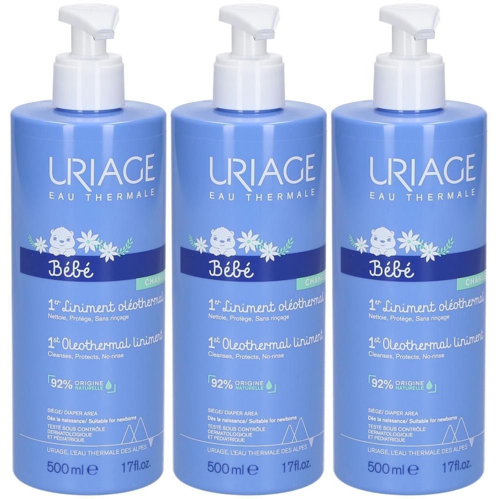 Drei blaue Flaschen mit weißem Pumpverschluss. Aufschrift: Uriage Bébé 1er Liniment oléothermal. 92% natürliche Inhaltsstoffe.