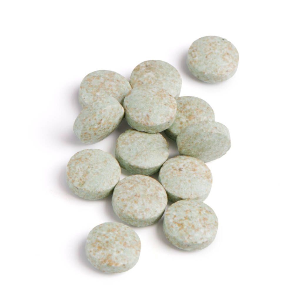 Twaalf groene tabletten op witte achtergrond. Ronde vorm, licht ongelijkmatig oppervlak.