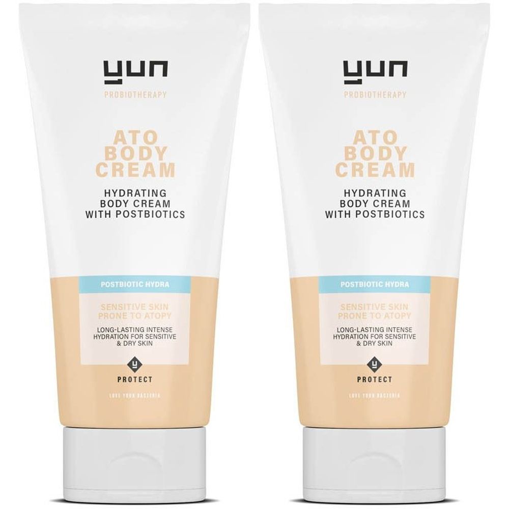 Twee tubes YUN ATO Body Cream. Witte tubes met tekst en productinformatie. Beige en lichtblauwe accenten.