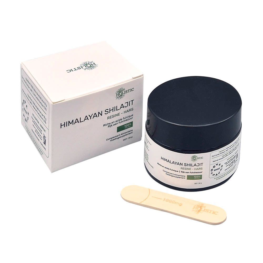 Witte doos en zwarte pot met houten spatel. Opschrift: Himalayan Shilajit Résine. Groen gemarkeerd: 100%.
