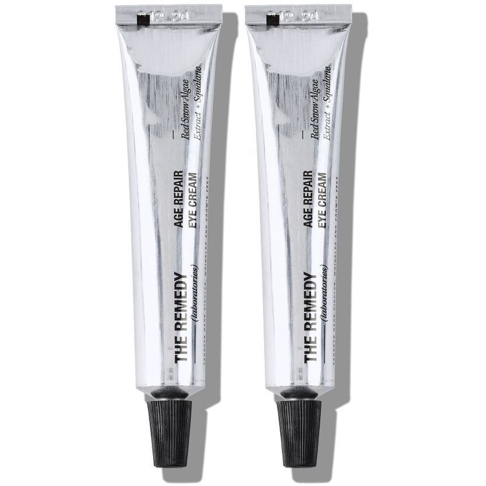 Twee tubes 'AGE REPAIR EYE CREAM'. Tekst: 'THE REMEDY (laboratories)'. Zilver, zwarte doppen.