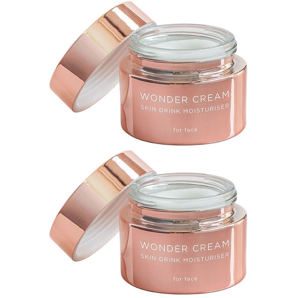 Deux pots roses ouverts. Inscription : Wonder Cream Skin Drink Moisturizer.