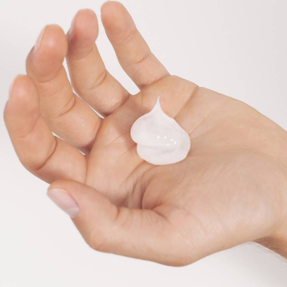 Une paume avec une petite quantité de mousse à raser blanche.