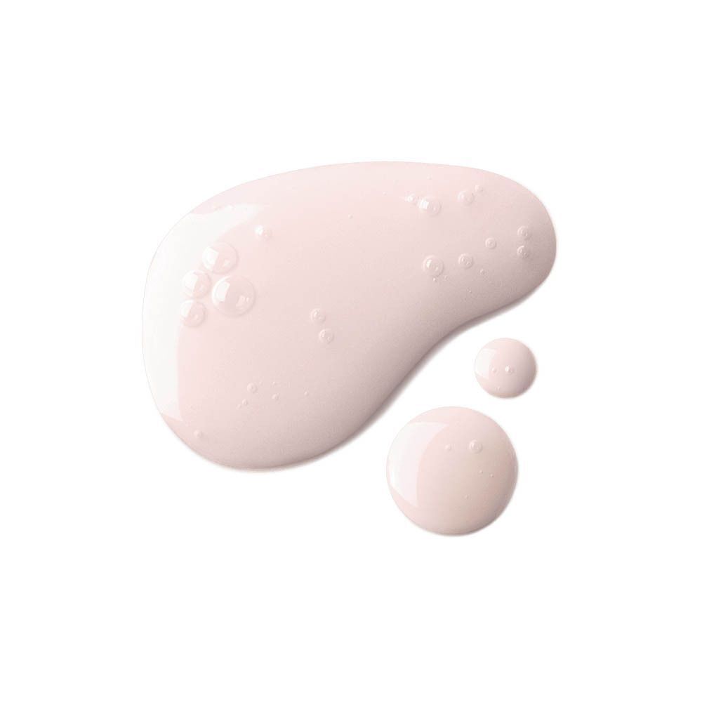 Gouttes de liquide rose sur fond blanc. Quelques gouttes plus petites sont également visibles.
