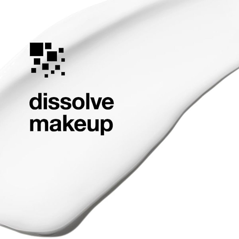 Weiße Creme mit Text 'dissolve makeup' und einem Symbol aus schwarzen Quadraten.