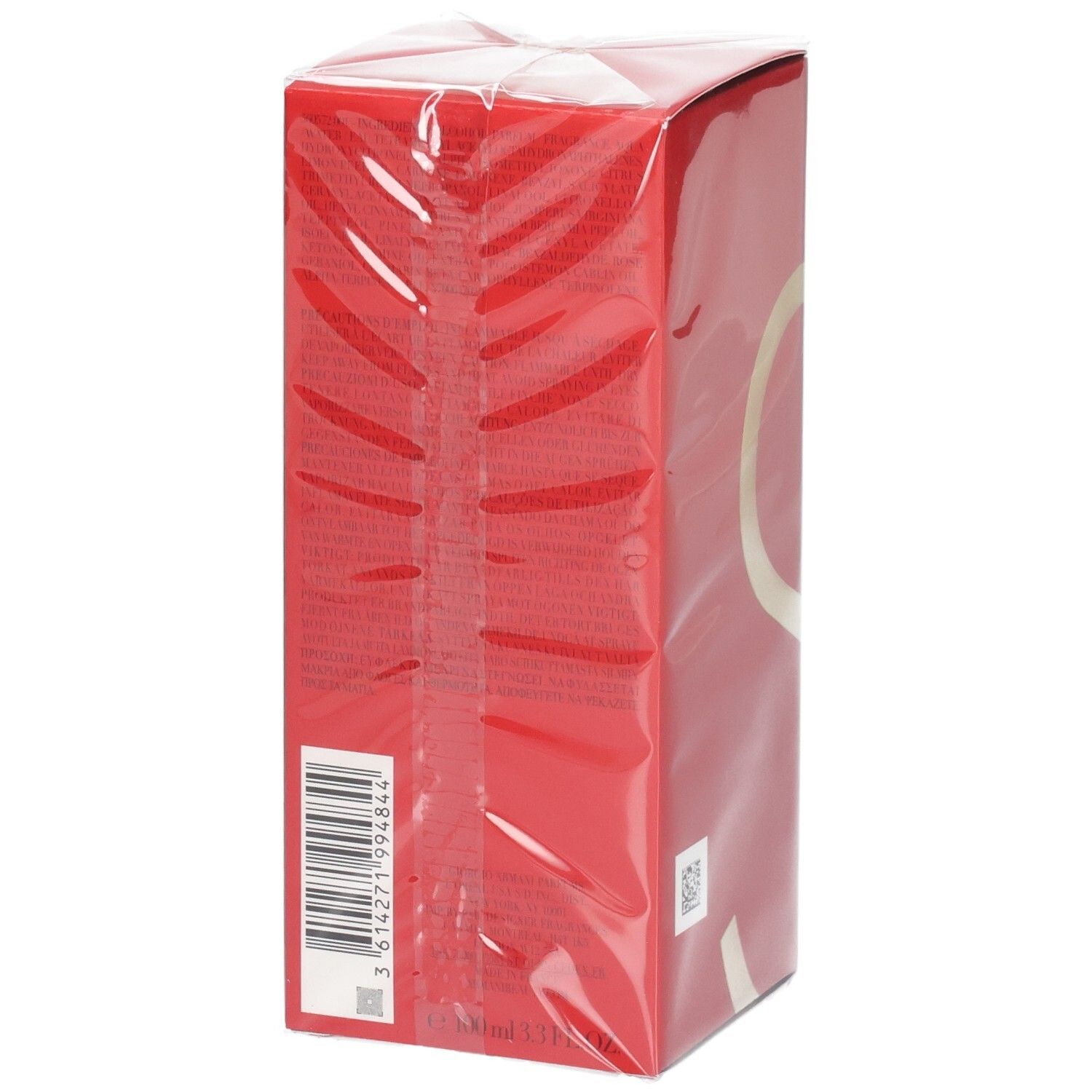 Rote Schachtel mit Barcode und goldenem Kreisdesign, in Klarsichtfolie verpackt.