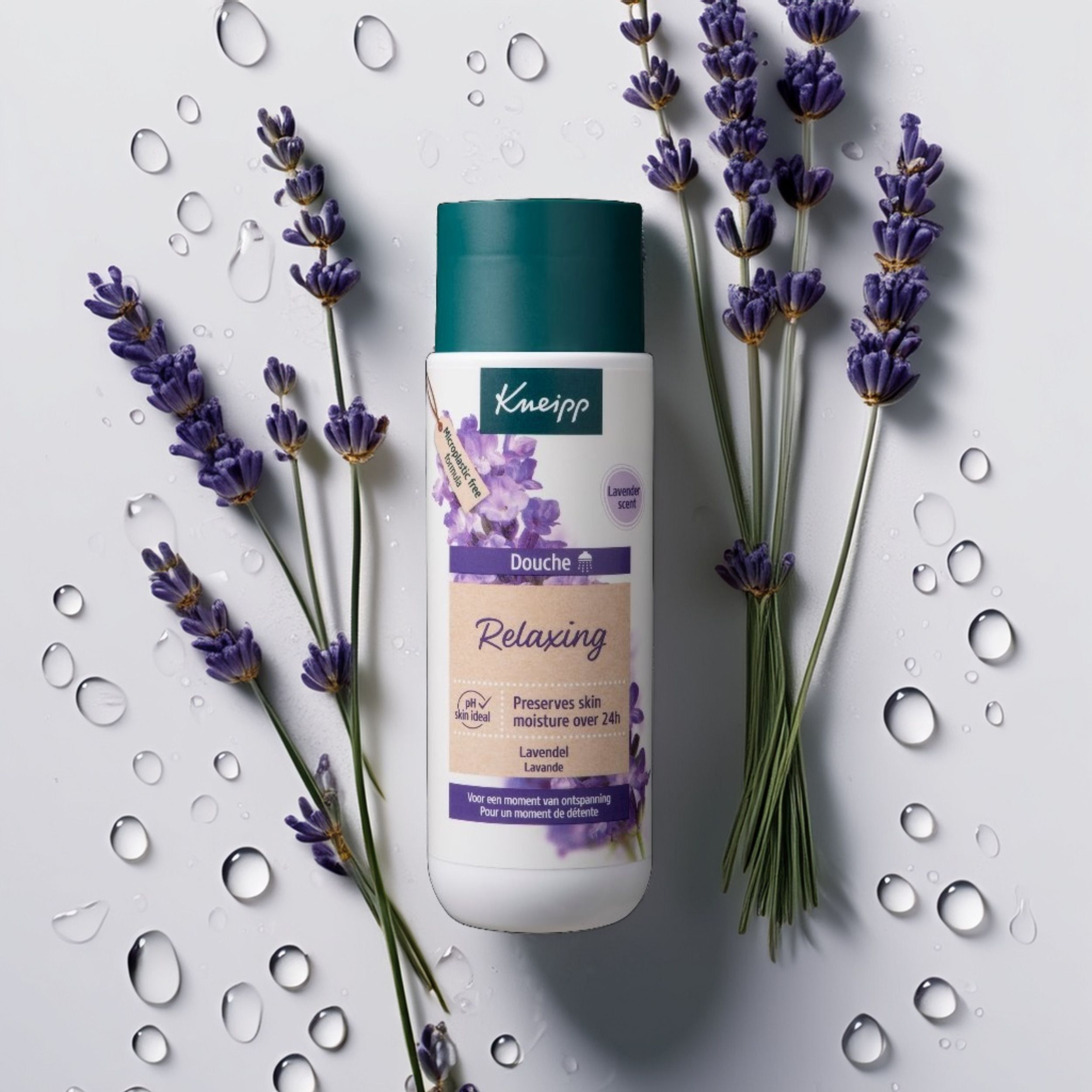 Kneipp Douche Relaxing fles met lavendeltakken en waterdruppels. Product op witte achtergrond.