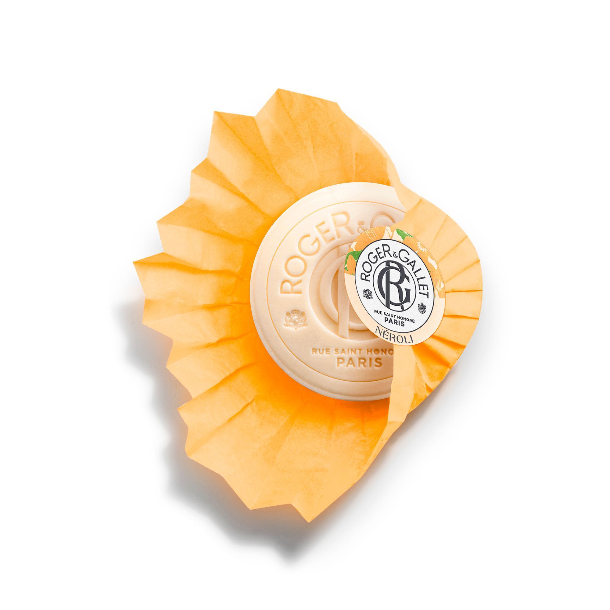 Savon Roger & Gallet Savon Bienfaisant NÉROLI, blanc, partiellement enveloppé dans du papier de soie orange.